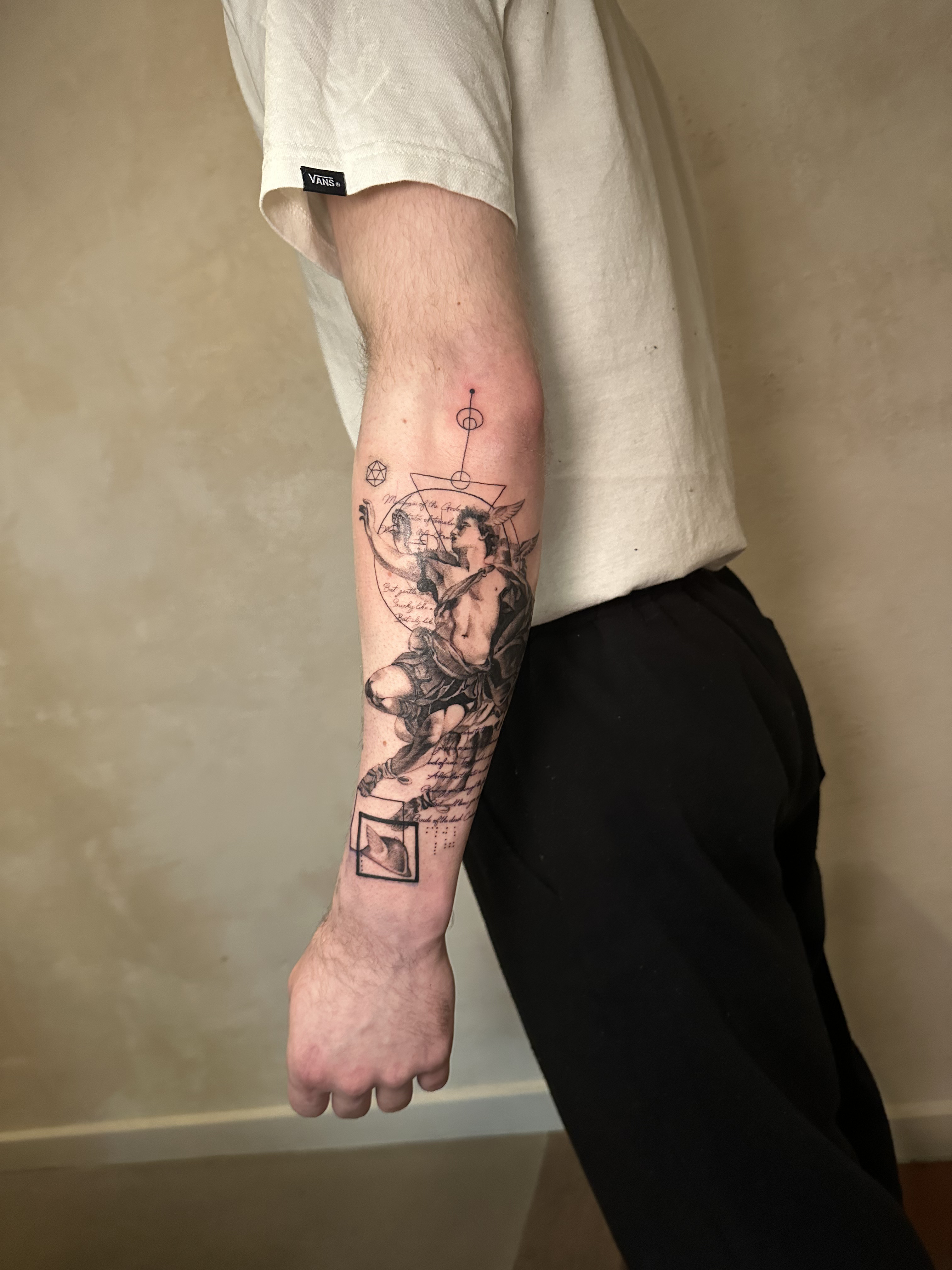 Fine art forearm tattoo of Hermes from classical mythology in black and grey.