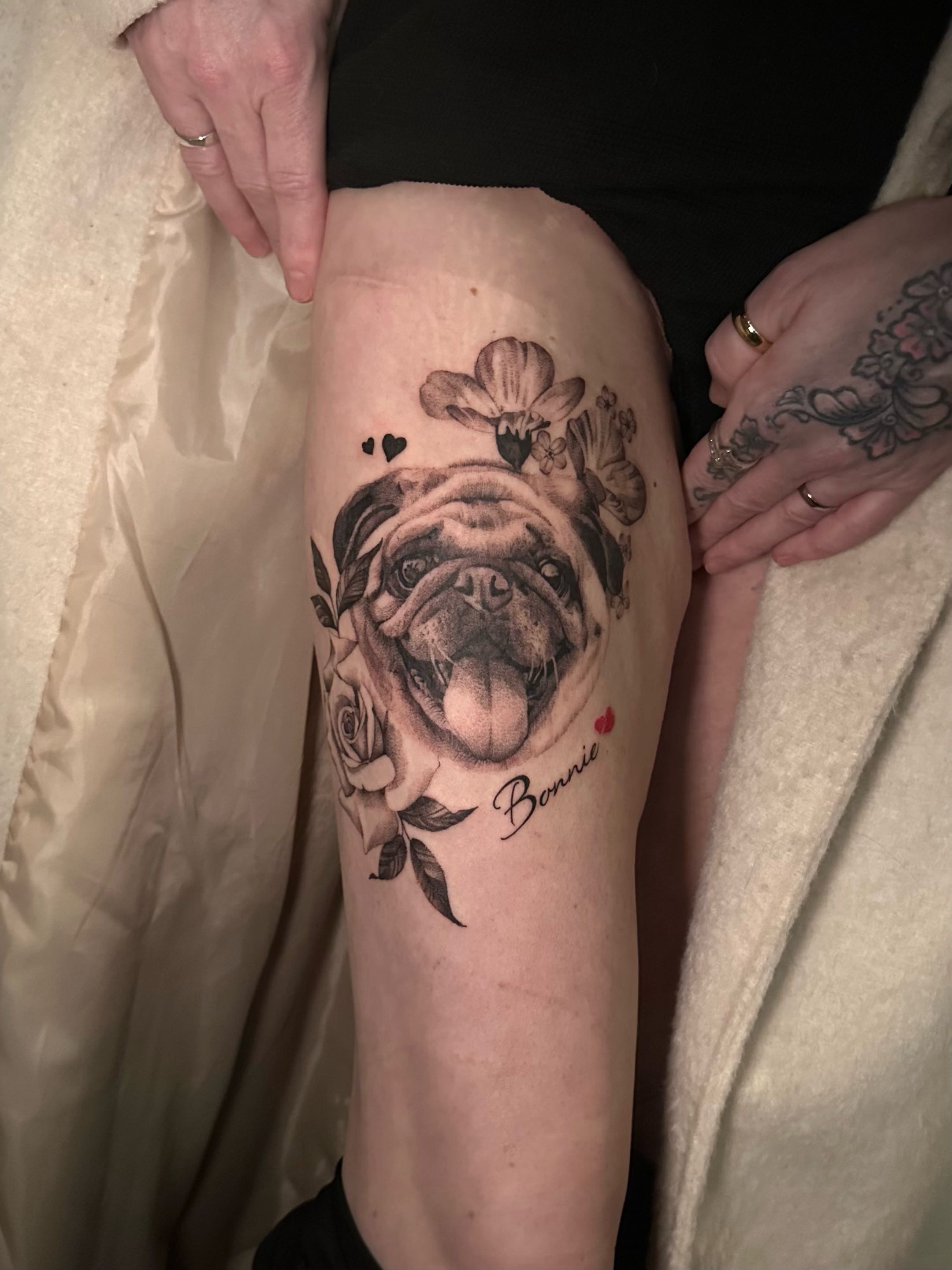 Realistic pug Bonnie portrait with roses and floral accents on thigh by Emmy, Hull