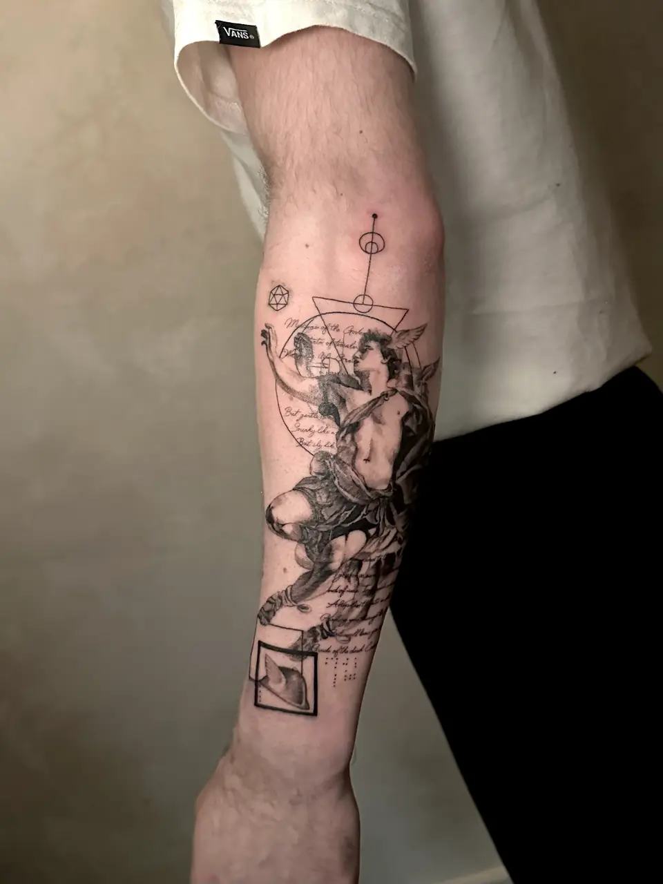 Classical Hermes figure with a winged cap, geometric lines and script on the forearm.