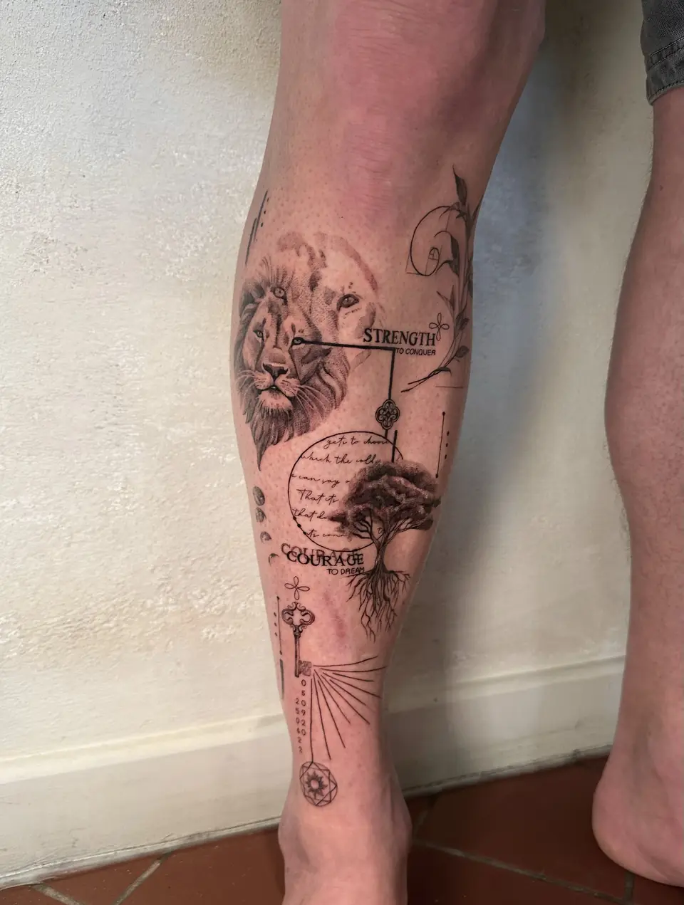 Lion portrait with a rooted tree, script, a key and geometric details along the lower leg.